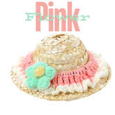 A pink knit trim around the brim with a mint-colored flower on the front.